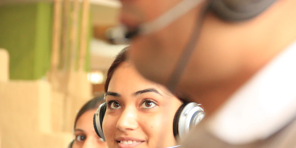 Customer support agents wearing headsets at work